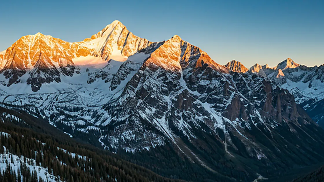 Stunning aerial view of the San Juan Mountains near Telluride at dawn with snow-capped peaks and deep blue shadows